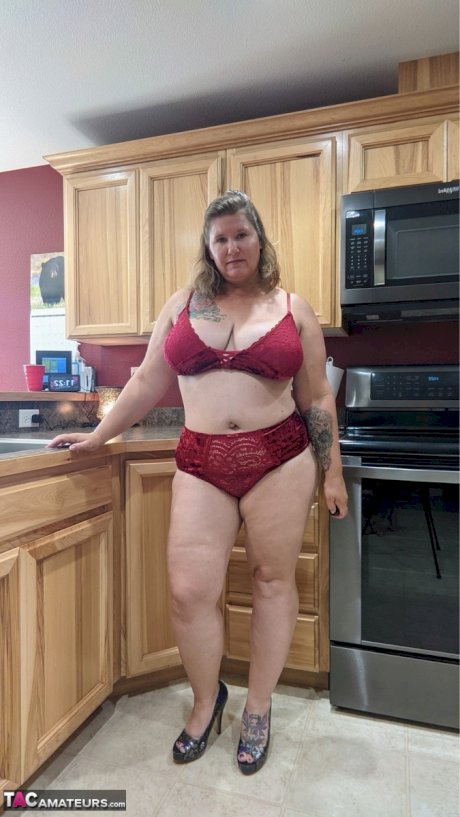 Amateur woman Busty Kris Ann shows her big tits and butt in her kitchen