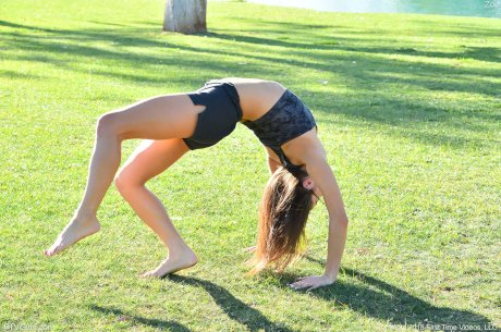 Teenage hottie in sexy outfit Zoe doing exercise outdoors by the water