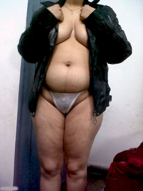 Fat Indian woman hides her face while adorned in a bra and thong