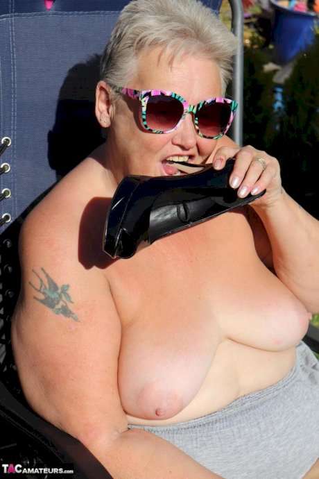 Fat nan Valgasmic Exposed licks a shoe while exposing herself in the backyard