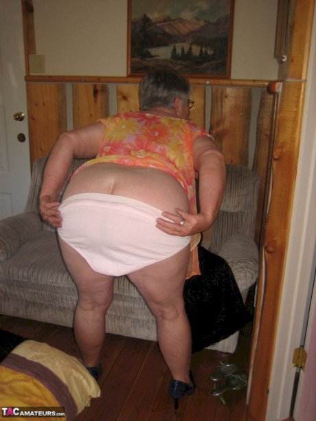 Obese granny Girdle Goddess wakes up from a nap and precedes to strip naked