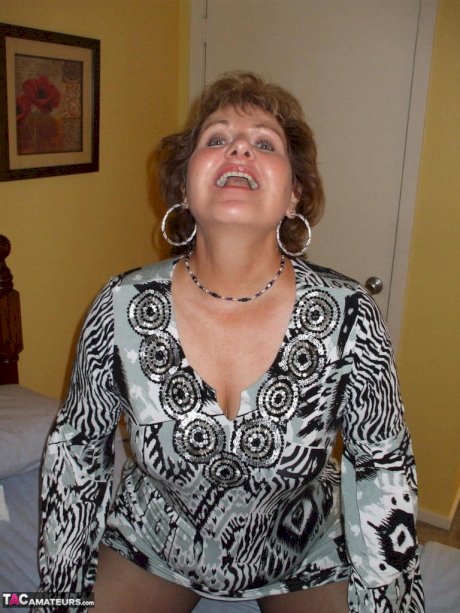 Mature woman tongue kisses her man before stripping and playing with his cock