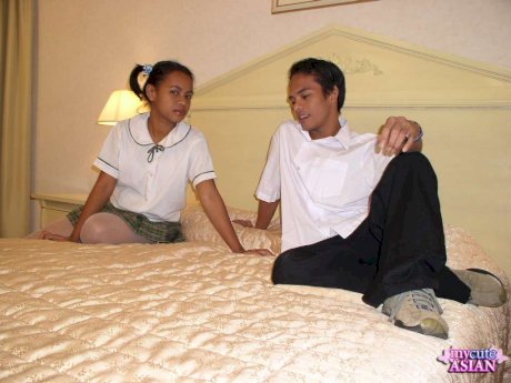 Asian schoolgirl gets cum on her innocent looking face on her parent's bed