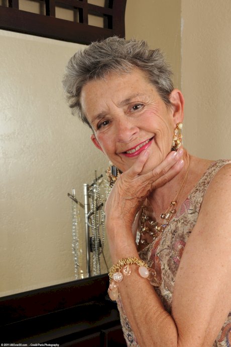 Slim granny Cassie doffs her dress and flaunts her bushy vagina