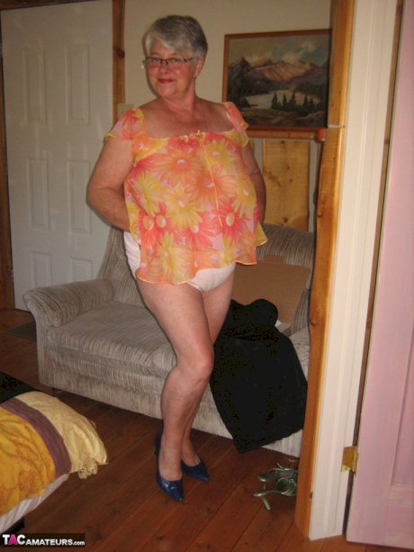 Obese granny Girdle Goddess wakes up from a nap and precedes to strip naked