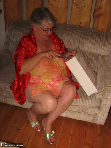 Obese granny Girdle Goddess wakes up from a nap and precedes to strip naked