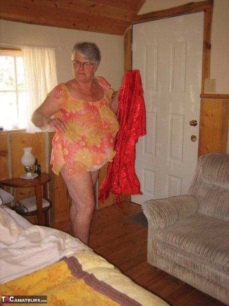 Obese granny Girdle Goddess wakes up from a nap and precedes to strip naked