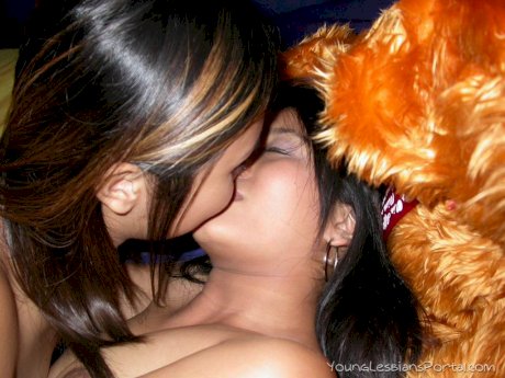 Young Asian girls undress before lesbian sex commences on a bed