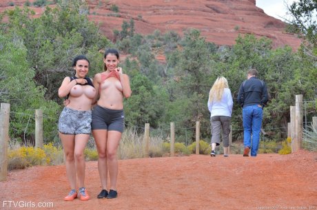 Amateur babe Saraya strips and poses naked with her busty friend in public