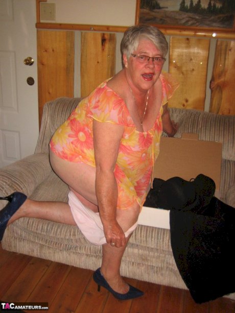 Obese granny Girdle Goddess wakes up from a nap and precedes to strip naked