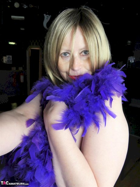 Older amateur Posh Sophia works a stripper pole inside an empty club