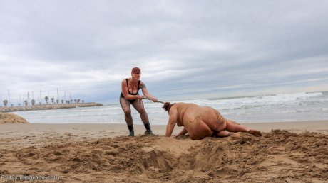 Slutty BBW Mimosa eats pussy while buried up to her neck in a kinky BDSM scene