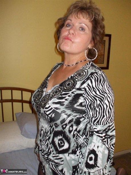 Mature woman tongue kisses her man before stripping and playing with his cock