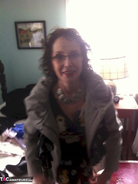 Curly haired mature woman likes sending her younger partner provocative photos