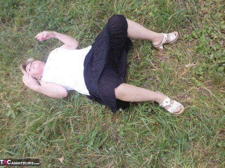 Mature amateur whore Caro masturbating on the bench in the woods