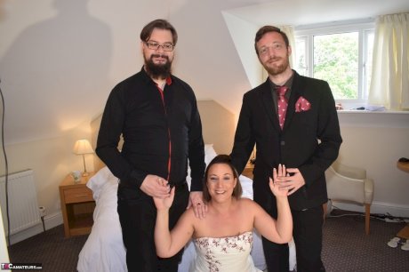 Amateur woman Sara Banks as her tits and pussy freed from a gown by two men