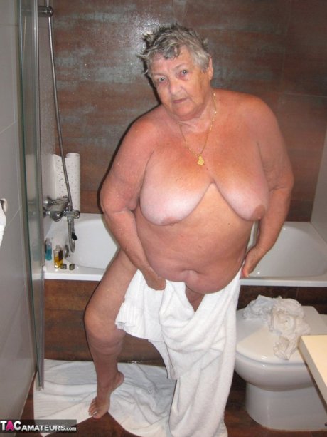 Obese amateur Grandma Libby blow drys her hair after taking a shower