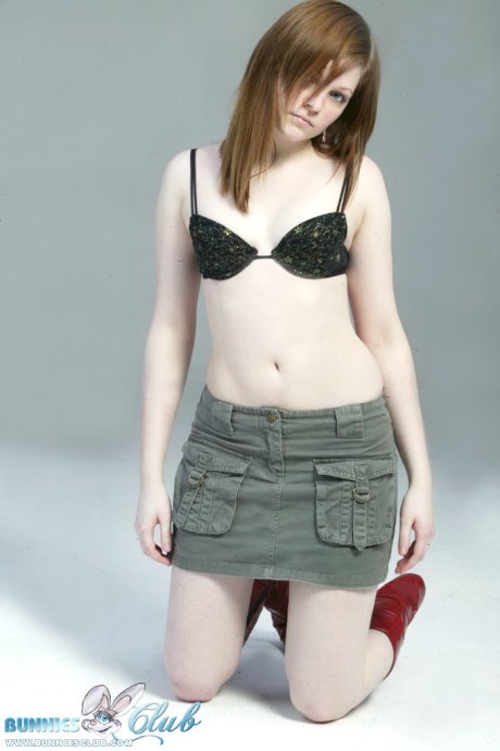 Pale redhead Lilly slowly strips to a black G-string and red leather boots