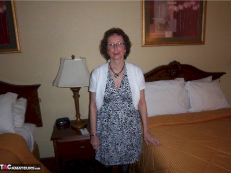 Curly haired mature woman likes sending her younger partner provocative photos