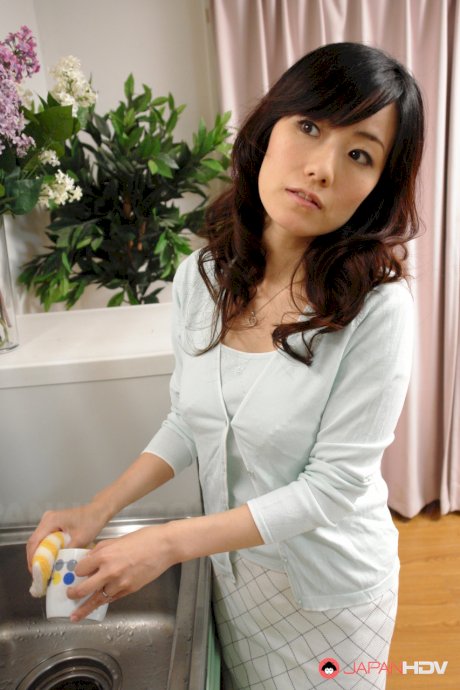 Asian wife Manami Komukai massages a guy before riding his cock