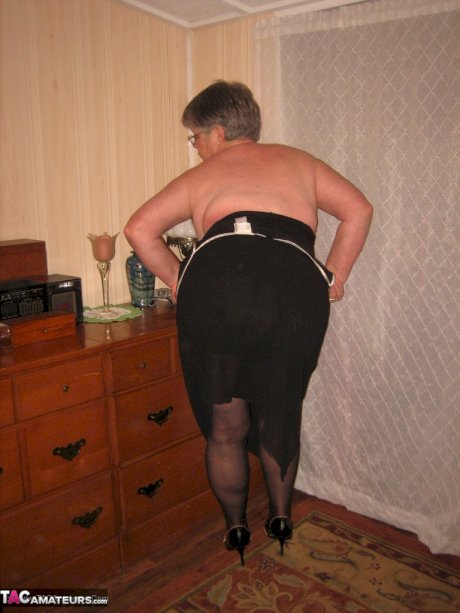 Overweight nan Girdle Goddess strips to her footwear in front of a dresser