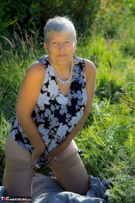 Silver haired granny Savana gets naked outdoors on a blanket in stockings