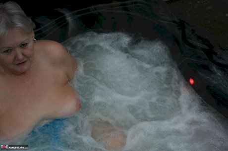 Old woman Valgasmic Exposed plays with her breasts while hot tubbing