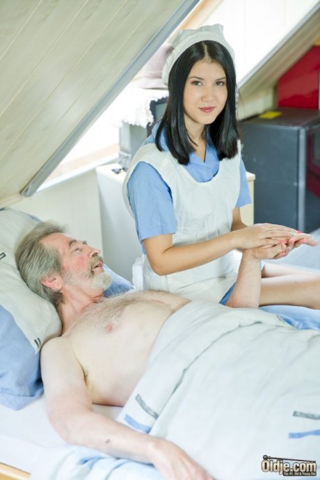 Dark haired nurse relieves her patient of his backed up jizz problem