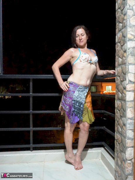 Mature woman Diana Ananta smokes a cigarette while exposing her snatch