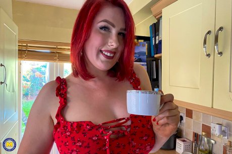 Middle-aged redhead works her big ass while getting naked in hosiery and heels