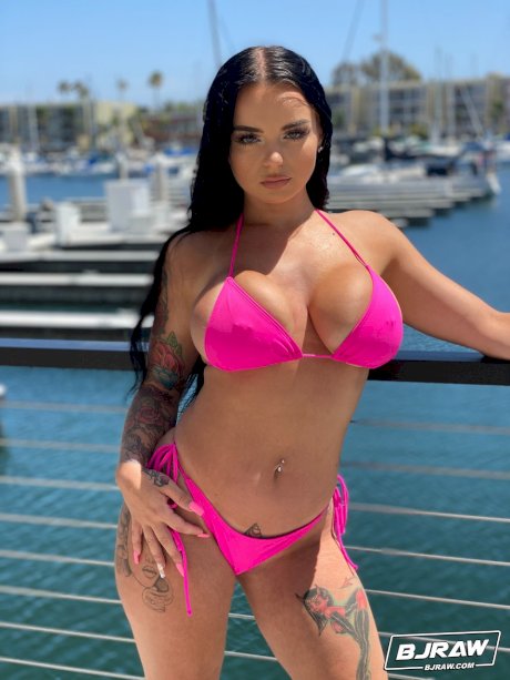 Curvaceous stunner Payton Preslee flaunting her huge melons in a pink bikini