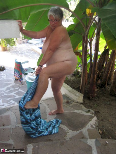 Old woman Girdle Goddess smokes before exposing her fat body on her patio