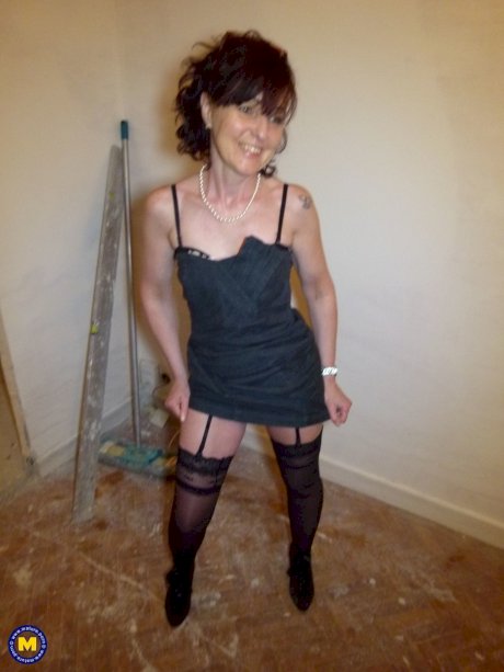 Mature brunette Joyce Mifle strips her clothes & poses in her lingerie