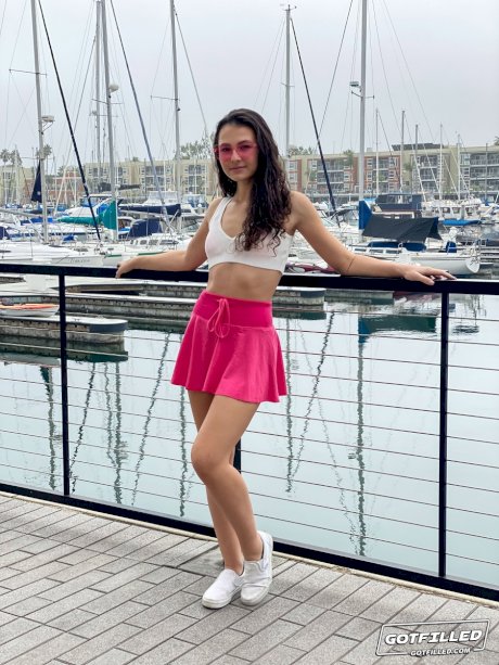 Young brunette Liz Jordan models a bikini at a marina before sex at home