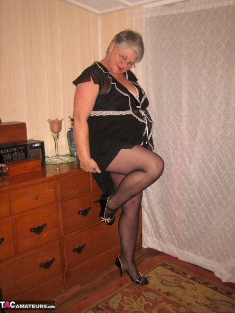 Overweight nan Girdle Goddess strips to her footwear in front of a dresser