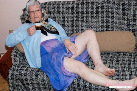 Cute granny with glasses Agnes strips and massages a nice fat dick