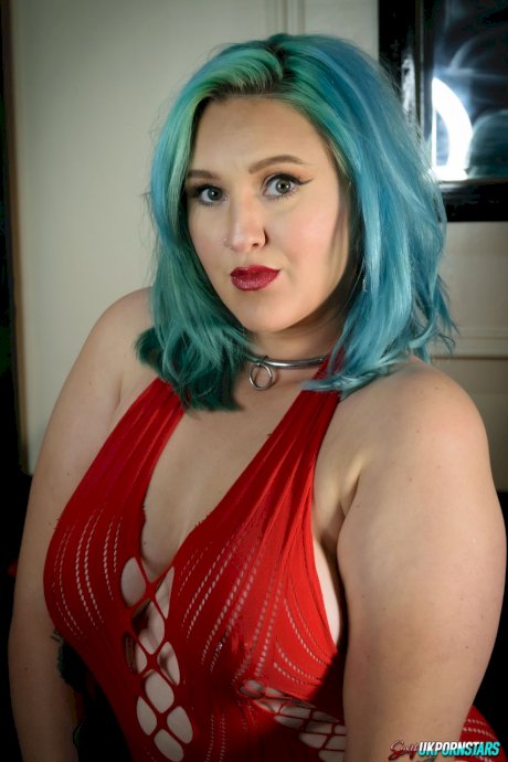 UK pornstar Ruby Fall lets her nipples slip free from a revealing red dress