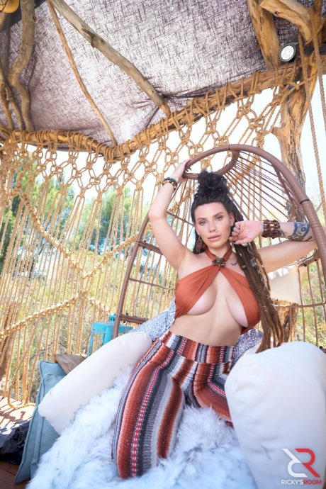 Young and busty brunette Indica Flower gets bare naked at a rural location