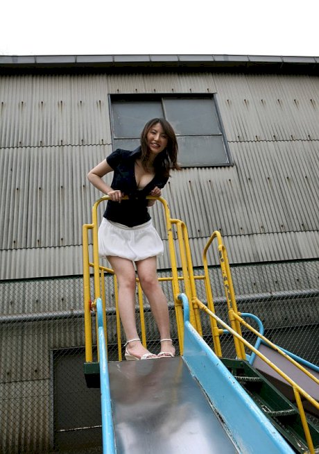 Japanese teen Takako Kitahara exposes upskirt panties on slide at playground