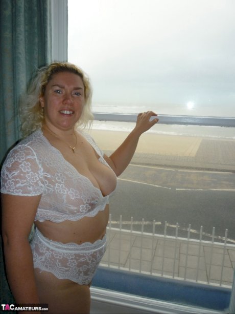 Mature blonde Barby fondles her big tits while masturbating during a shower
