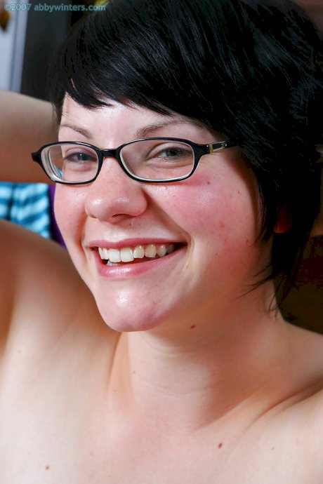 Fat chick with glasses gets undressed and flashes hairy pussy