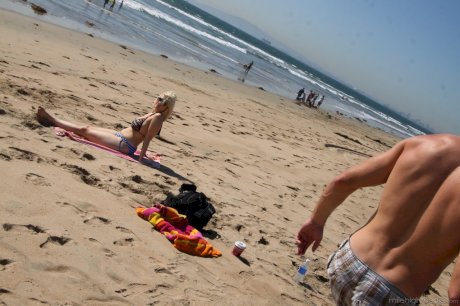 Chubby blonde sunbather Siri flaunts her big tits in a bikini on the beach