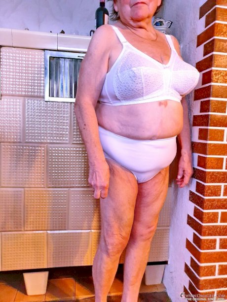 Granny with red lipstick Bagra undresses and displays her big saggy tits