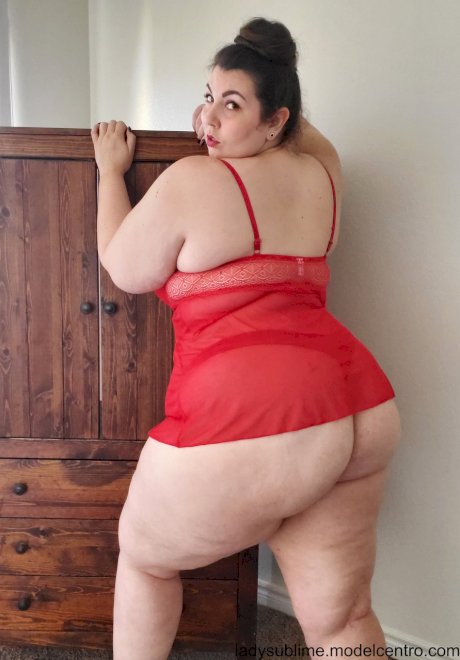 Fatty in a red negligee Lady Sublime flaunts her big juggs while sucking a toy