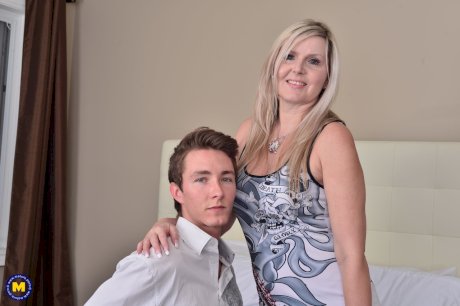 Middle aged woman shows her neighbor's boy the ways of sex in her bedroom