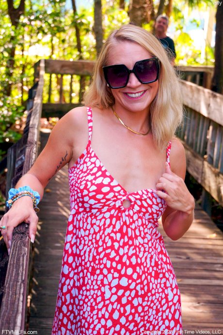 Skinny blonde Ally gets totally naked on a public beach in sunglasses