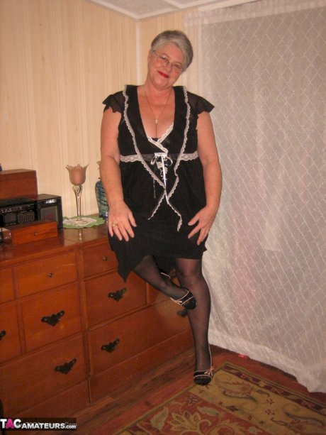 Overweight nan Girdle Goddess strips to her footwear in front of a dresser