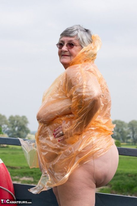 Obese oma Grandma Libby doffs a see-through raincoat to get naked on a bridge