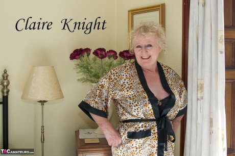 Blonde granny admires herself in a mirror while wearing lingerie and nylons