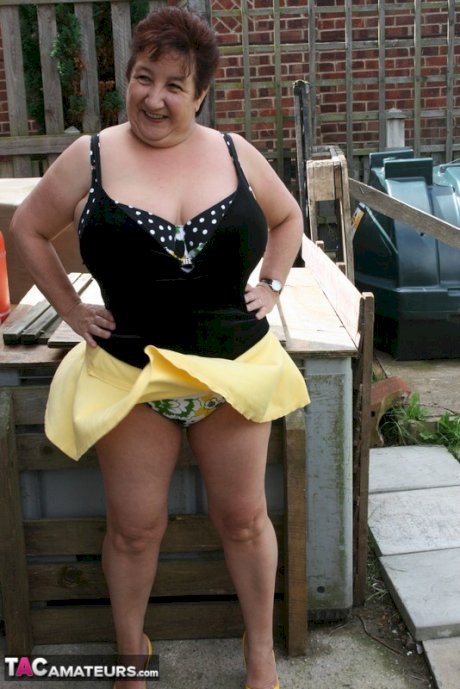 Fat older woman Kinky Carol flashes her bra and upskirt underwear on a patio